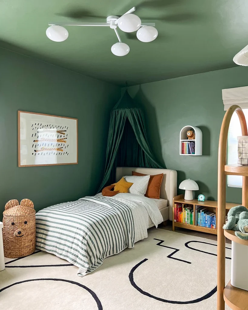 Moody green toddler room with bookshelf bed and canopy