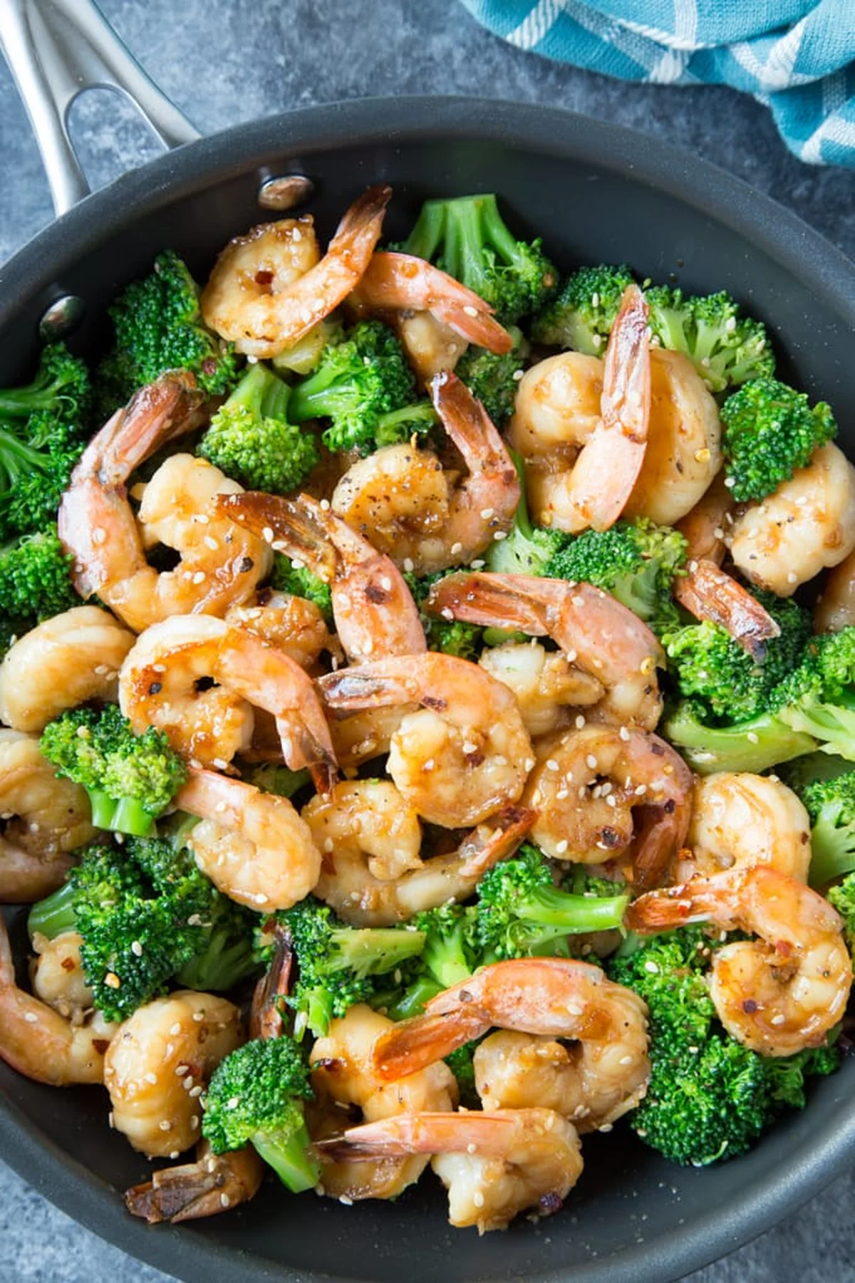 Cooked honey garlic shrimp plated with sesame seeds