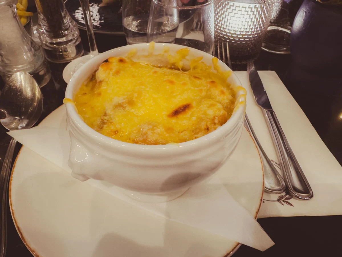 Steaming bowl of French onion soup with Gruyere cheese