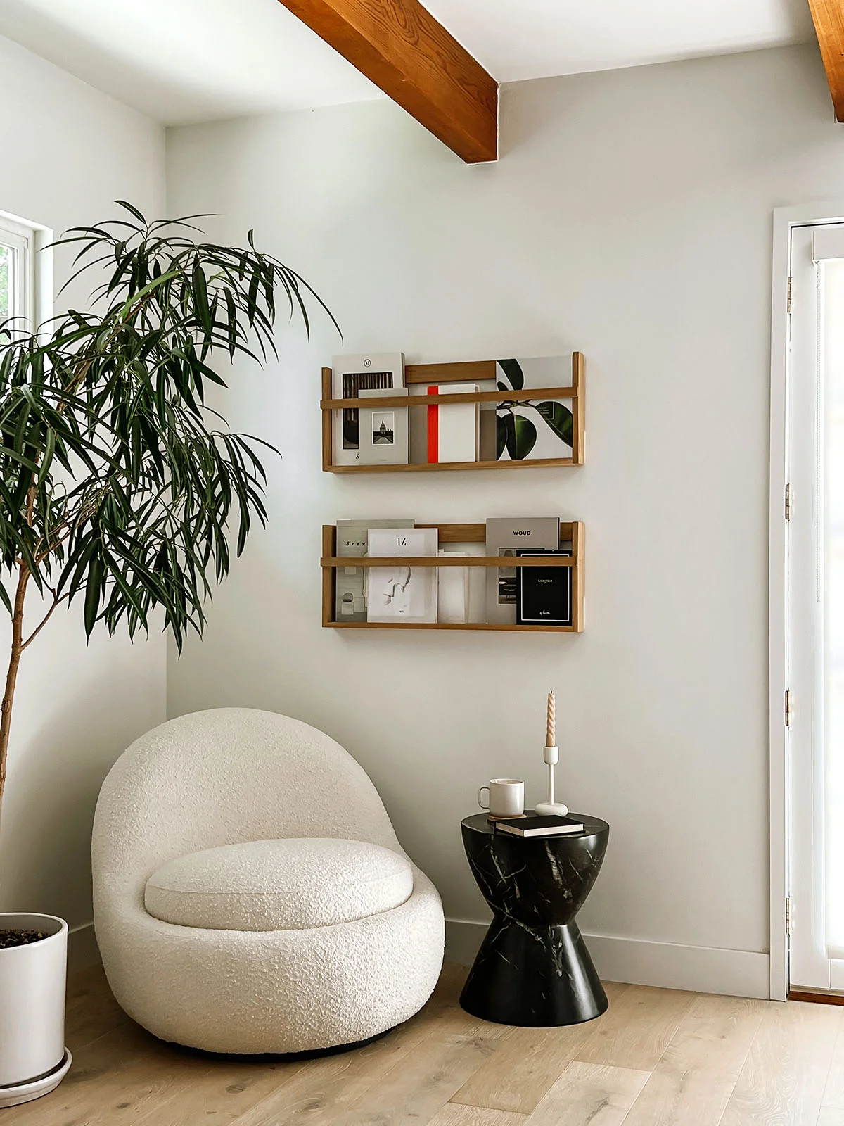 Magazine wall racks beside black tiered shelf unit
