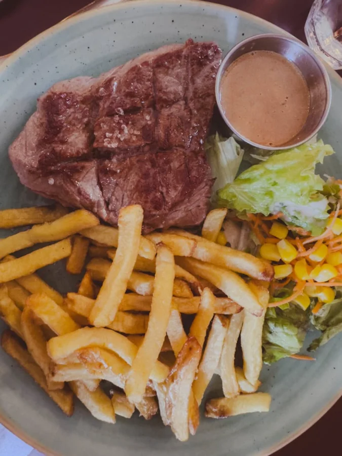 Classic steak frites at a Parisian bistro table