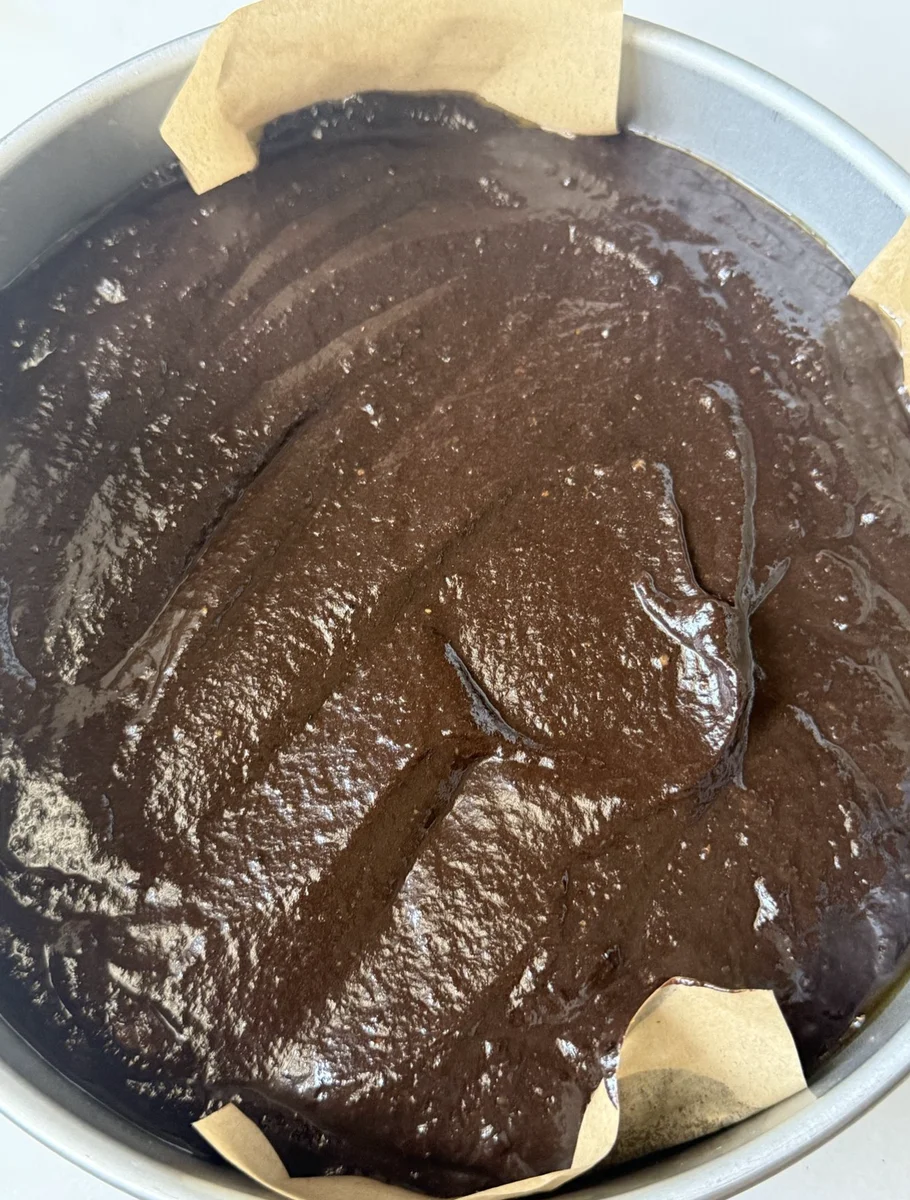 Smooth chocolate cake batter in springform pan before baking