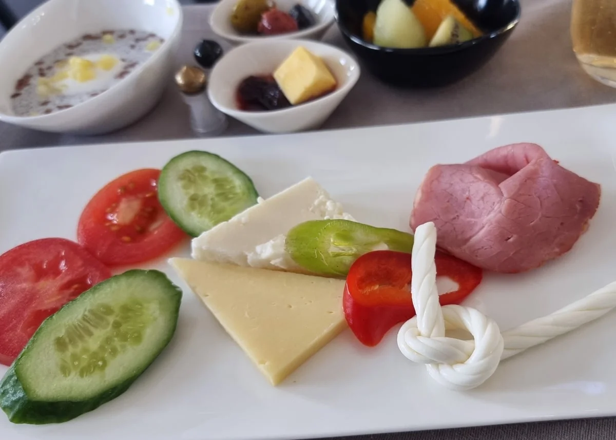 Top-down view of a fresh breakfast plate with vegetables and cheese