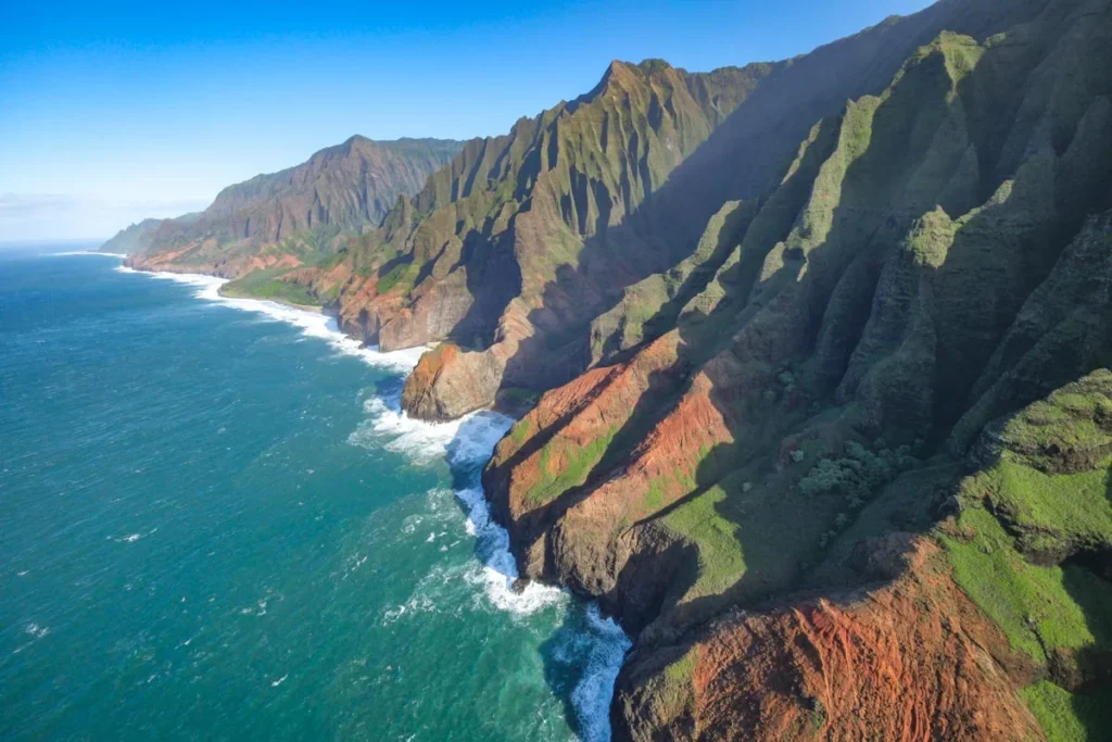 Aerial view of Kauai's green cliffs from a helicopter