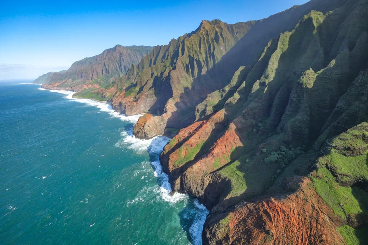 Aerial view of Kauai's green cliffs from a helicopter