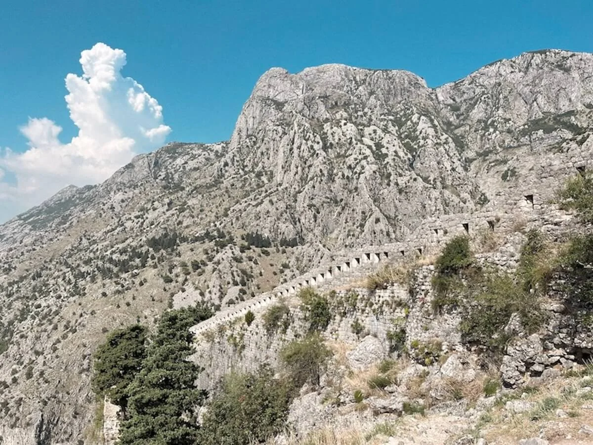 Stone fortress walls climbing above Kotor's old town