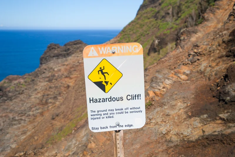 Warning signs clustered at the Kalalau trailhead